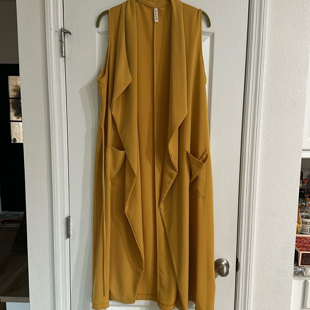 Yellow women’s jacket/vest style cover up.